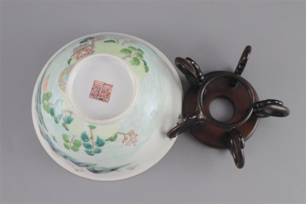 A Chinese enamelled landscape porcelain bowl, Jiaqing mark and of the period (1796-1820), 15.5cm diameter, wood stand